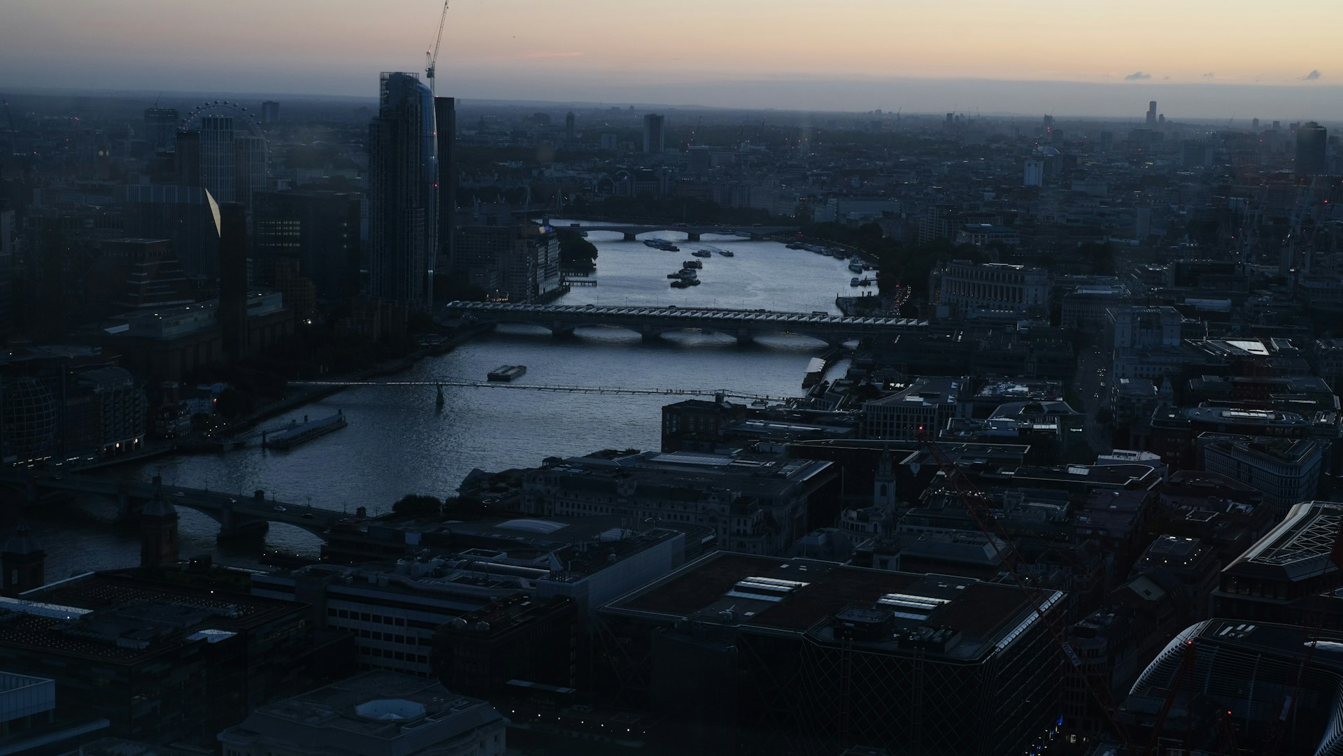 Aerial cityscape with river and bridges at dusk